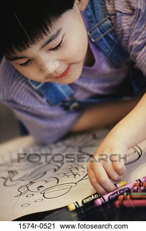 Boy coloring with crayons in a coloring book View Large Photo Image Stock Image - Boy coloring with crayons in a coloring book. Fotosearch