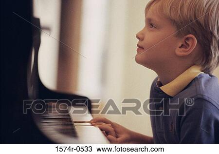 Boy playing the piano View Large Photo Image Stock Image - Boy playing the piano. Fotosearch