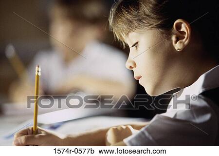 Close-up of a boy writing with a pencil View Large Photo Image Stock Image - Close-up of a boy writing with a pencil. Fotosearch