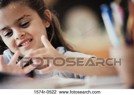 Stock Image - Close-up of a girl counting on her fingers. Fotosearch