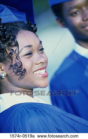Stock Image - Close-up of students standing together wearing their graduation outfits. Fotosearch