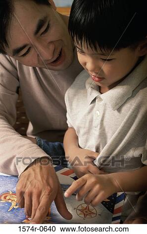 Father helping his son study View Large Photo Image Stock Image - Father helping his son study. Fotosearch