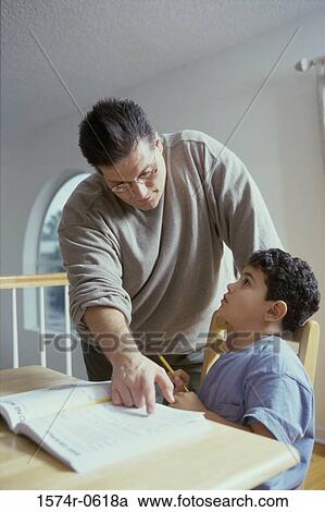 Father helping his son with homework View Large Photo Image Stock Image - Father helping his son with homework. Fotosearch