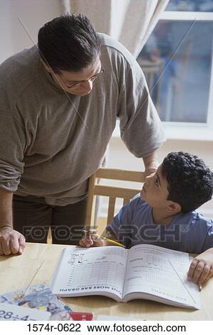 Father helping his son with homework View Large Photo Image Stock Image - Father helping his son with homework. Fotosearch