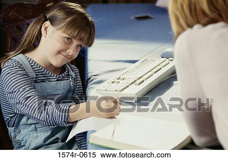 Girl sitting with her mother and studying View Large Photo Image Stock Photography - Girl sitting with her mother and studying. Fotosearch
