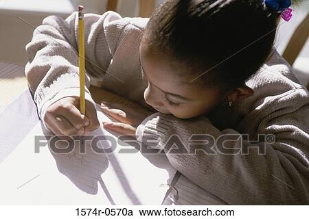 Stock Image - Girl writing with a pencil. Fotosearch
