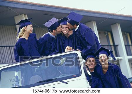 Stock Image - Group of graduating students sitting in an all terrain vehicle. Fotosearch