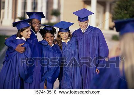 Group of students standing together wearing their graduation outfits View Large Photo Image Stock Photo - Group of students standing together wearing their graduation outfits. Fotosearch
