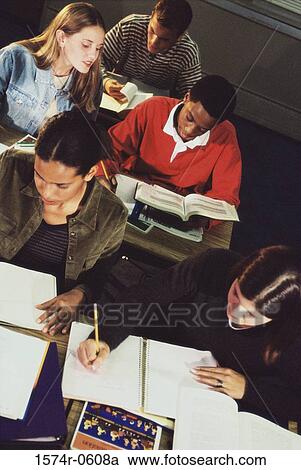 Stock Image - High angle view of teenage students taking a test in class. Fotosearch