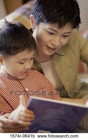 Stock Image - Mother and child reading a book. Fotosearch