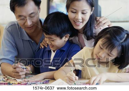 Mother and father with their children coloring together View Large Photo Image Stock Photo - Mother and father with their children coloring together. Fotosearch