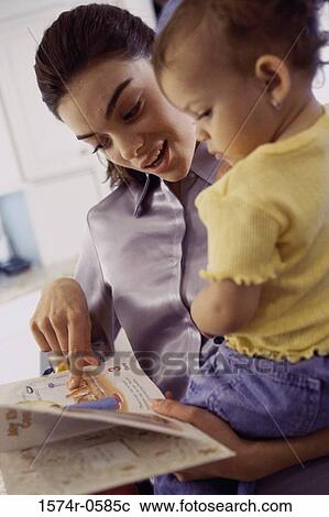 Stock Image - Mother and her child reading a book. Fotosearch