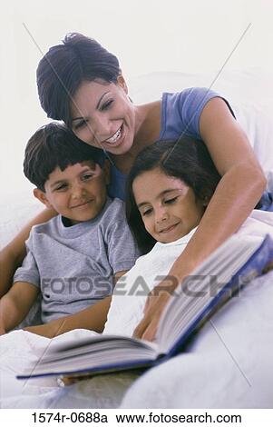 Mother and her two children reading a book View Large Photo Image Stock Image - Mother and her two children reading a book. Fotosearch