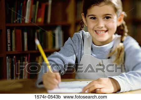 Portrait of a girl writing with a pencil on paper View Large Photo Image Stock Image - Portrait of a girl writing with a pencil on paper. Fotosearch