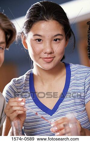 Stock Photo - Portrait of a teenage girl holding a pipette. Fotosearch