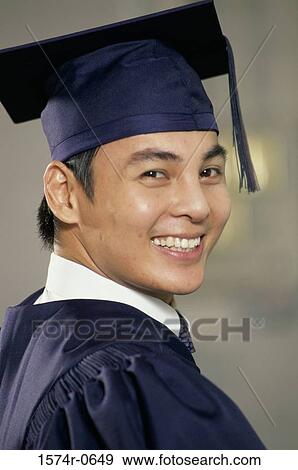 Stock Photo - Portrait of a young man wearing a graduation outfit. Fotosearch