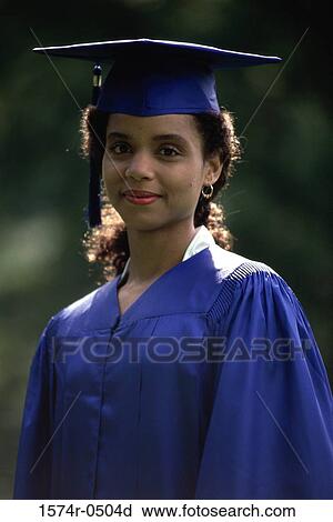 Stock Image - Portrait of a young woman wearing a graduation outfit. Fotosearch