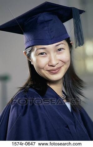 Stock Photo - Portrait of a young woman wearing a graduation outfit. Fotosearch