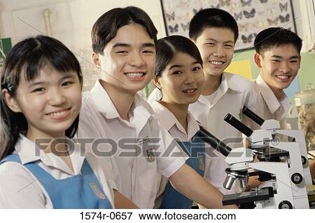 Stock Photo - Portrait of teenage students in a science laboratory. Fotosearch