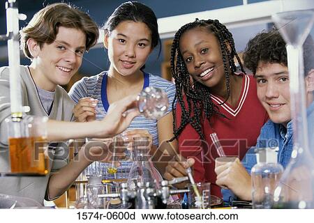 Stock Image - Portrait of teenagers at a chemistry laboratory. Fotosearch