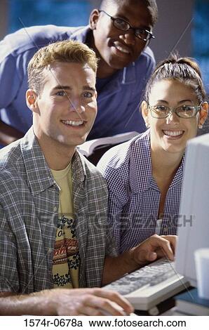 Portrait of two young men and a young woman studying together View Large Photo Image Stock Image - Portrait of two young men and a young woman studying together. Fotosearch