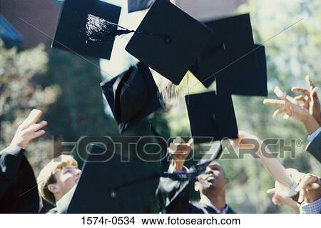 Picture - Students throwing their graduation hats in the air during a graduation ceremony. Fotosearch