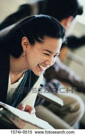 Teenage girl smiling in class View Large Photo Image Stock Photography - Teenage girl smiling in class. Fotosearch