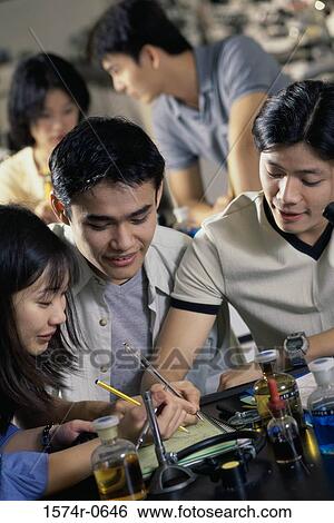 Teenage students working in a laboratory View Large Photo Image Stock Photograph - Teenage students working in a laboratory. Fotosearch