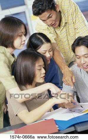 Stock Image - Teenage students working together. Fotosearch