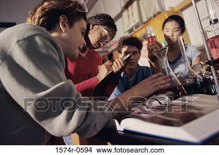 Teenagers conducting an experiment in a chemistry laboratory View Large Photo Image Picture - Teenagers conducting an experiment in a chemistry laboratory. Fotosearch