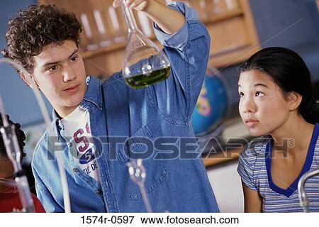 Teenagers conducting an experiment in a chemistry laboratory View Large Photo Image Stock Photo - Teenagers conducting an experiment in a chemistry laboratory. Fotosearch