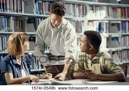 Three people at a library View Large Photo Image Stock Image - Three people at a library. Fotosearch
