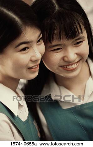 Stock Image - Two teenage girls smiling. Fotosearch