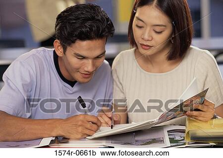 Stock Image - Two teenage students in a class. Fotosearch
