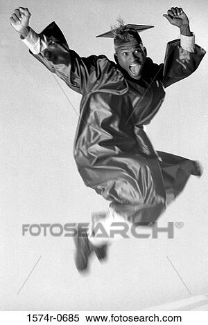 Young man wearing a graduation outfit jumping in the air View Large Photo Image Stock Photography - Young man wearing a graduation outfit jumping in the air. Fotosearch