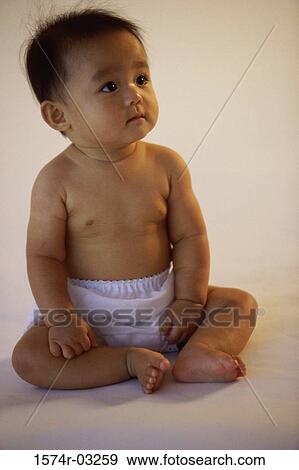 Baby boy sitting and looking up View Large Photo Image Stock Photo - Baby boy sitting and looking up. Fotosearch