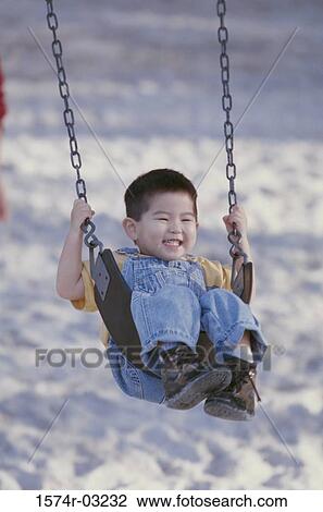 Boy playing on a swing View Large Photo Image Stock Image - Boy playing on a swing. Fotosearch