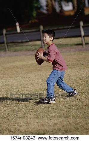 Boy playing with a rugby ball View Large Photo Image Stock Image - Boy playing with a rugby ball. Fotosearch