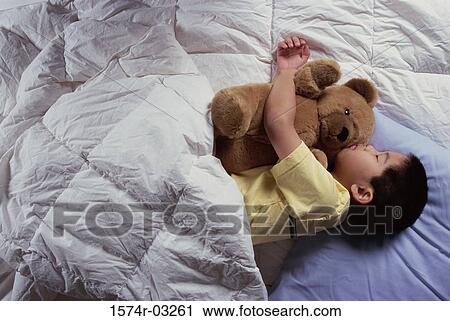 Boy sleeping with a teddy bear View Large Photo Image Stock Image - Boy sleeping with a teddy bear. Fotosearch