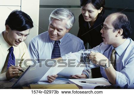 Stock Image - Business executives in a meeting. Fotosearch
