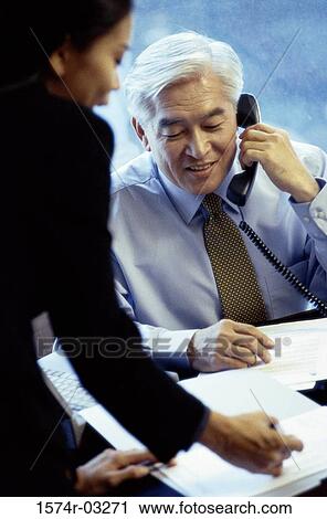 Businessman and a businesswoman in an office View Large Photo Image Stock Image - Businessman and a businesswoman in an office. Fotosearch