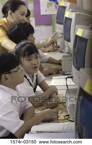 Stock Image - Children sitting in a computer lab. Fotosearch