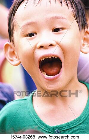 Close-up of a boy with his mouth open View Large Photo Image Stock Photo - Close-up of a boy with his mouth open. Fotosearch