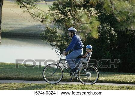 Father and son on a bicycle View Large Photo Image Stock Image - Father and son on a bicycle. Fotosearch