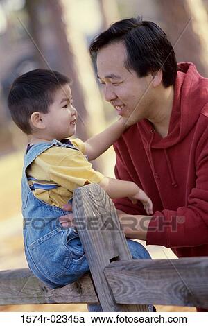 Father holding his son View Large Photo Image Stock Image - Father holding his son. Fotosearch