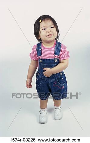 Girl standing and smiling View Large Photo Image Stock Photograph - Girl standing and smiling. Fotosearch