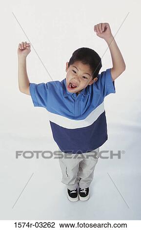 High angle view of a boy with his arms raised View Large Photo Image Stock Image - High angle view of a boy with his arms raised. Fotosearch