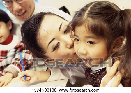 Mother kissing her daughter View Large Photo Image Stock Photo - Mother kissing her daughter. Fotosearch