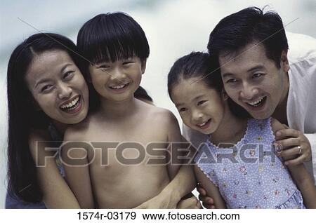 Parents holding their son and daughter View Large Photo Image Stock Photo - Parents holding their son and daughter. Fotosearch