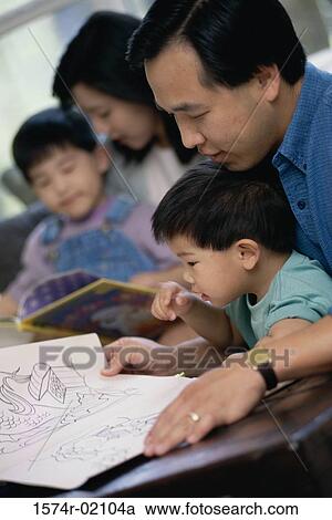 Parents watching their two sons coloring with crayons View Large Photo Image Stock Image - Parents watching their two sons coloring with crayons. Fotosearch